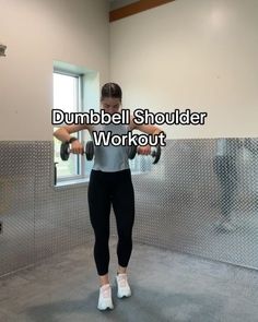 a woman is doing dumbbell shoulder workout