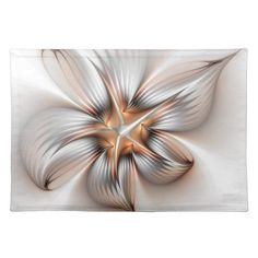 a white and gold flower with an intricate design on the center placemats are shown