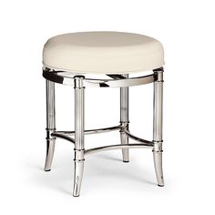 a white stool sitting on top of a wooden table