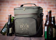 a cooler bag sitting on top of a wooden table next to bottles of wine and beer