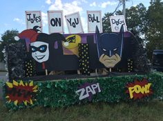 an outdoor display with batman masks and pop - up signs on it's sides