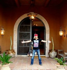 a man standing in front of a doorway with his arms outstretched and hands out to the side