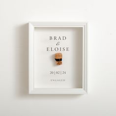 a wine cork in a white frame with the words brad and eloise