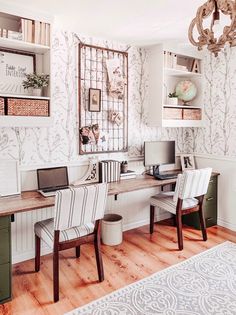 a desk with two chairs and a laptop on it