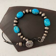 This is a lovey petite Kingman turquoise bracelet with four nuggets averaging 12-14 mm in size.  The are separated by sterling silver Navajo pearls and attach with a handmade sterling silver button.  This is a beautiful one of a kind piece that will look great with other silver pieces.  This bracelet fits a 6.5 inch wrist. Adjustable Southwestern Style Bracelet With Silver Beads, Southwestern Style Adjustable Silver Beads Bracelet, Adjustable Southwestern Style Silver Beaded Bracelets, Southwestern Style Adjustable Silver Beaded Bracelet, Adjustable Southwestern Jewelry With Silver Beads, Adjustable Southwestern Silver Beaded Jewelry, Rustic Adjustable Jewelry With Polished Beads, Rustic Silver Beaded Jewelry, Adjustable Southwestern Silver Beaded Bracelets