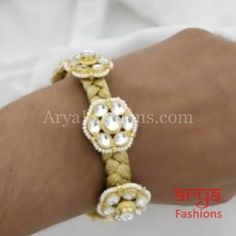 Golden Kundan Bracelet/Bridal Indian Kundan Bracelet/Jadau Polki Bracelet Bangle Features: Made in Brass with 22 Karat Gold polish Thickness: Approx. 0.65 Inches Available in size 2.6,2.8 Made in Brass with very high quality Kundan stones and golden thread base Bracelet comes with loop tie back feature. White Meenakari Bracelets For Puja, Traditional Adjustable Bracelets With Gota Work, Adjustable Traditional Bracelets With Gota Work, White Bracelets For Puja And Festive Occasions, White Cutdana Bracelets For Puja, Adjustable Gold Bracelet With Intricate Design For Wedding, Adjustable Intricate Design Gold Wedding Bracelet, Adjustable Gold Wedding Bracelet With Intricate Design, Adjustable Meenakari Bracelets For Puja