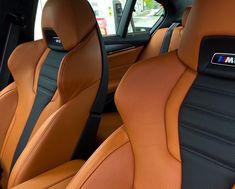 the interior of a car with tan leather and black stitching on the front seats