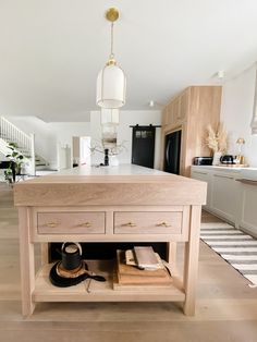 a kitchen with an island made out of wood and some drawers on the bottom shelf