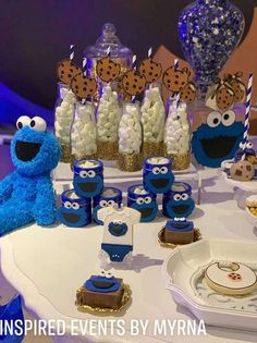 cookie monster dessert table with cookies, marshmallows, and other treats on it