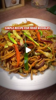 a white plate topped with noodles and vegetables