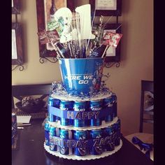 a birthday cake made out of soda cans