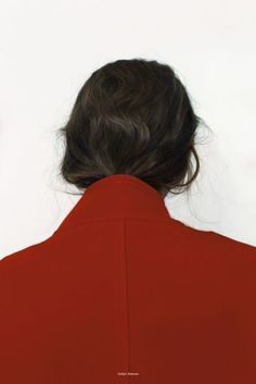 the back of a woman's head wearing a red jacket