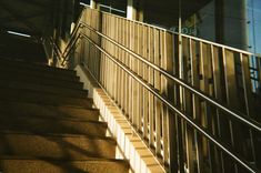 stairs leading up to the top of a building with metal railings and handrails