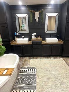 a bathroom with two sinks, mirrors and a rug on the floor in front of it