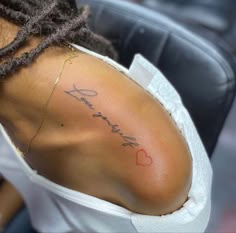 the back of a woman's shoulder with her name written on it