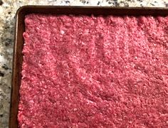 raw ground beef in a baking pan ready to be cooked and put into the oven