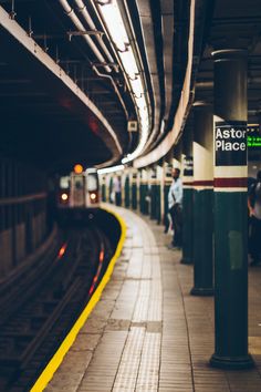 a subway station with people waiting for the train