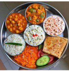 a metal plate topped with different types of food