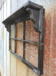 an old window on the side of a building