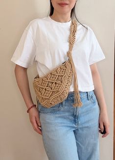 Our versatile Macrame Sling Bag, a must-have accessory that seamlessly blends style and functionality. Whether you wear it as a crossbody bag, sling it across your body, or sport it as a trendy fanny pack, this boho-inspired purse is the perfect addition to any outfit. Crafted with meticulous attention to detail, our Macrame Sling Bag features an intricate woven design that exudes bohemian charm. Made from a durable blend of 70% cotton and 30% polyester, it's as sturdy as it is stylish. With its Bohemian Beige Bag With Mobile Phone Bag, Bohemian Beige Bag With Mobile Phone Pocket, Summer Everyday Pouch Belt Bag, Summer Crossbody Belt Bag, Summer Belt Bag For Everyday Use, Summer Crossbody Belt Bag With Removable Pouch, Bohemian Crochet Mobile Phone Bag For Summer, Casual Handmade Adjustable Shoulder Bag, Casual Summer Crossbody Belt Bag