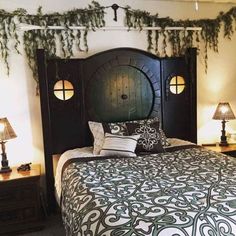 a bed with green and white comforter next to two lamps