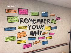 a bulletin board that says, remember your why on the wall is decorated with post - it notes