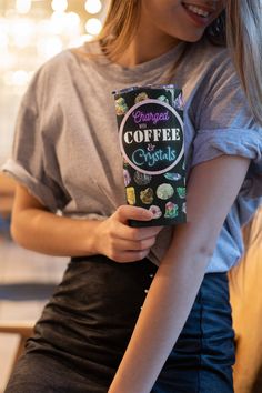 a woman holding a bag of coffee in her hands