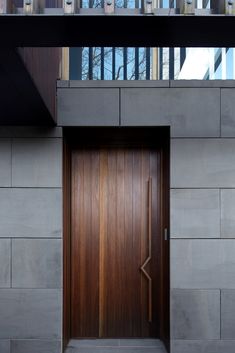 a wooden door on the side of a building