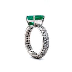 Capture modern glamour with this captivating engagement ring! Crafted in platinum, this pave set ring is sure to dazzle in any light. A stunning 2.30 carat emerald cut emerald forms the focal point of the design, surrounded by a halo of one hundred and six (106) pave-set diamonds that weigh a total of 1.90 carats. The square cut emerald reflects a vivid green hue, while the natural diamonds sparkle with a timeless brilliance. This elegant and vibrant ring will become a treasured heirloom for yea Emerald Cut Platinum Jewelry With Pave Setting, Luxury Emerald-cut Ring With Pave Setting, Luxury Emerald Cut Emerald Ring In White Gold, Formal Emerald Cut Emerald Ring With Pave Setting, Luxury Emerald Cut Cubic Zirconia Emerald Ring, Fine Jewelry Emerald Cut Diamond Ring With Pave Setting, Silver Emerald Cut Ring With Pave Setting, Luxury Emerald Cut Emerald Ring With Center Stone, White Gold Emerald-cut Ring With Pave Setting