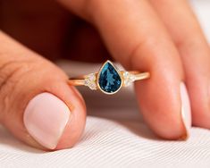 "Pear Cut London Blue Topaz Engagement Ring,14k Solid Gold Cluster Diamond Ring,Solitaire Proposal Ring,Delicate Jewelry,Elegant Promise Ring ★ ★ ★ ★  CUSTOM/DUTY-FREE SHIPPING WORLDWIDE, BUYERS DON'T HAVE TO PAY ANY CUSTOM FEES WHILE IMPORTING ★ ★ ★ ★  Details Made to order Material: 14k/18k Gold Color Options: Yellow Gold, White Gold, Rose Gold,  ★ Center Stone:  London Blue Topaz, Pear Size: 5 x 7 mm Approx Weight (Ct): 0.69 ★ Accent Stones:  Diamond/Moissanite, Round Size: 1.5 mm * 6 No.s Approx Weight (Ct): 0.084 ★ 100% Natural Diamond and Gemstones ★ Diamond: Round Brilliant cut, G-H Color, SI Clarity ☂ Shipped with Insured Shipping within 4-7 business days. ➦ 100% Free Returns. ➦ Our Jewelry comes with a Lifetime Warranty. (Stone Replacement not included) ✈ We offer free EXPRESS shi