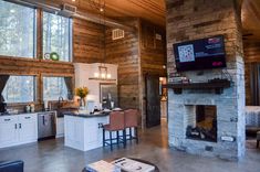 a living room filled with furniture and a flat screen tv mounted to a wall next to a fire place