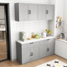 a kitchen with white walls and gray cabinets