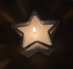 a lit candle in the shape of a star