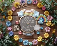 a baby announcement surrounded by fake flowers and other items on a wooden surface with the words, you're so proud to be able to be all we know our little people is one