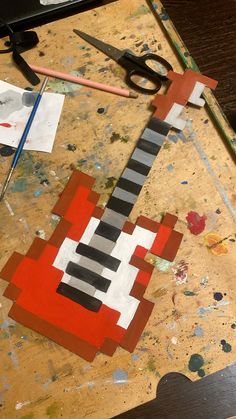 a piece of art that looks like a guitar is being made out of construction paper