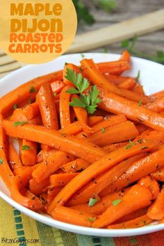 a white bowl filled with sliced carrots on top of a table