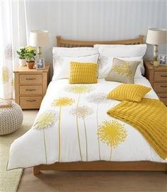 a bed room with a neatly made bed and pillows