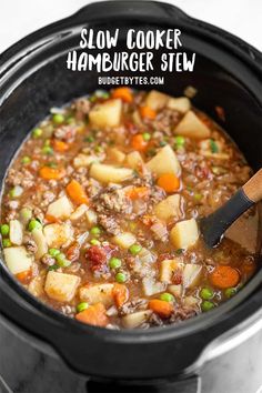 slow cooker hamburger stew in a crock pot with a wooden spoon and text overlay reading slow cooker hamburger stew