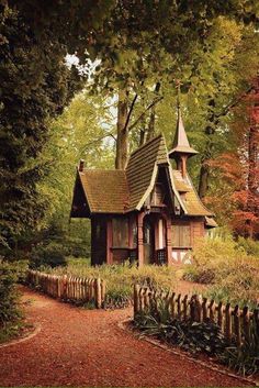 an image of a house in the woods with trees and leaves on it's sides