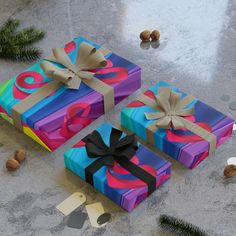 three wrapped presents sitting on top of a table