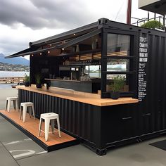 an outdoor bar with stools next to it