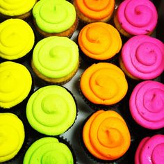 there are many cupcakes with different colored frosting