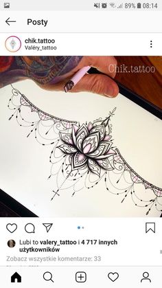 someone is drawing on paper with a pen and inking it in the shape of a flower