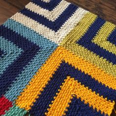 a crocheted blanket is laying on the floor