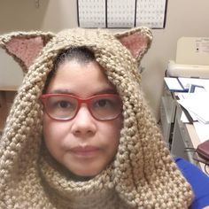 a woman wearing glasses and a knitted animal hood