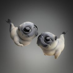 two small pug figurines floating in the air