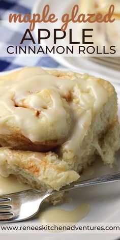 an apple cinnamon roll on a plate with a fork next to it and the words maple glazed apple cinnamon rolls