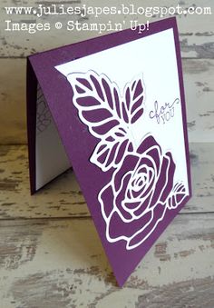 a close up of a card with a flower on the front and bottom corner,