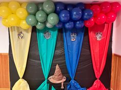 a room with balloons and wizard hats on the wall