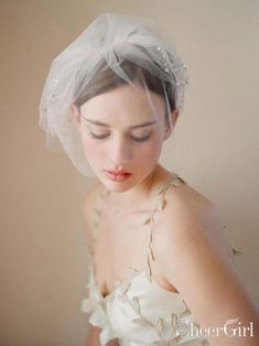 a woman in a wedding dress wearing a veil